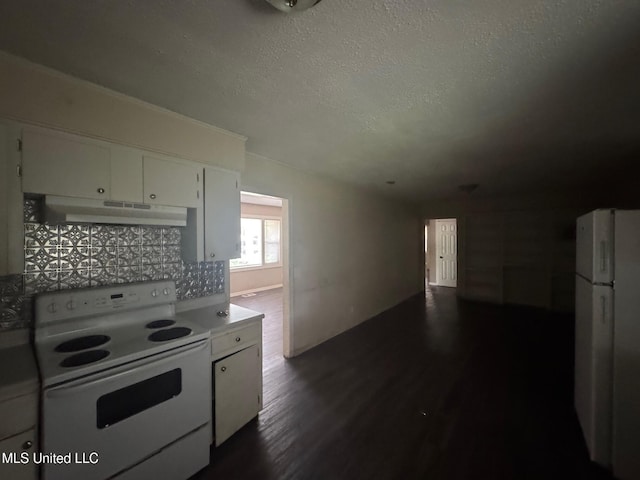 1870 Wisteria Dr, Jackson, MS 39204 - kitchen featuring under cabinet range hood, white appliances, dark wood-type flooring, white cabinets, and a textured ceiling