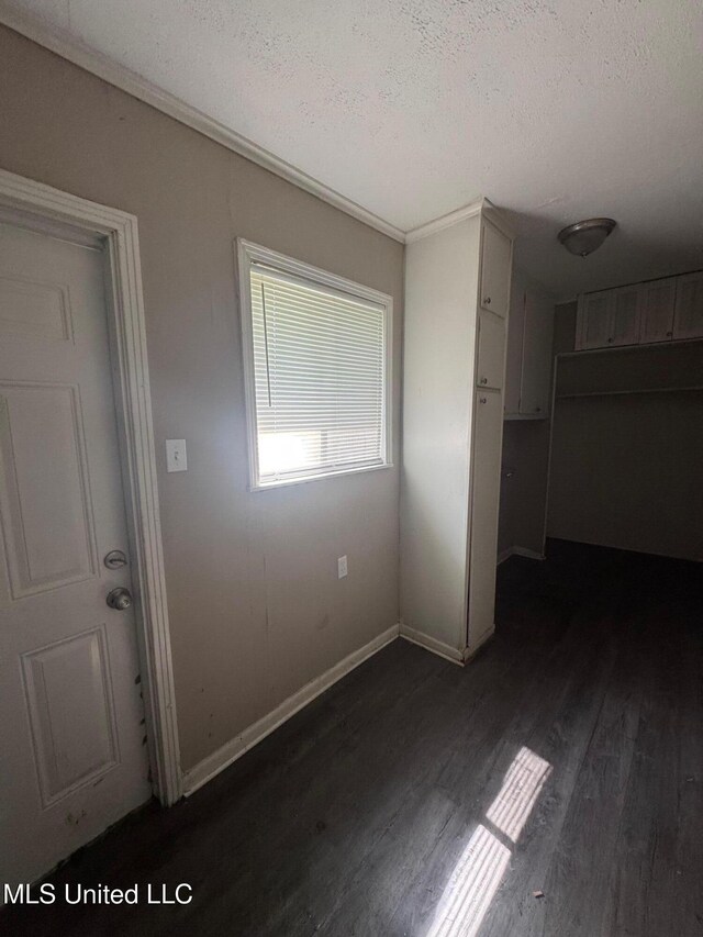 1870 Wisteria Dr, Jackson, MS 39204 - unfurnished bedroom with dark wood finished floors, a textured ceiling, and baseboards