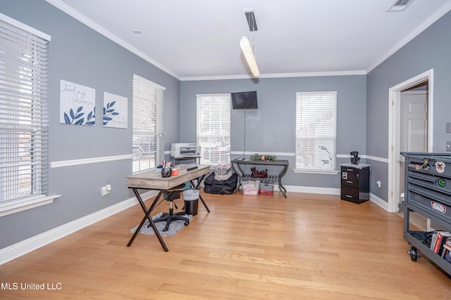 home office featuring crown molding and light hardwood / wood-style floors