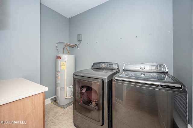 clothes washing area with water heater and washer and dryer