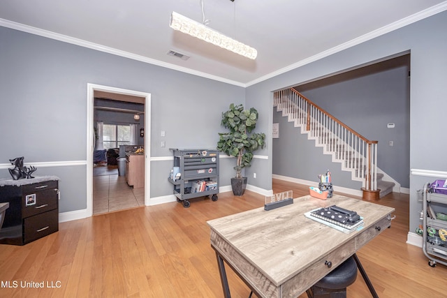 office area with crown molding and light wood-type flooring