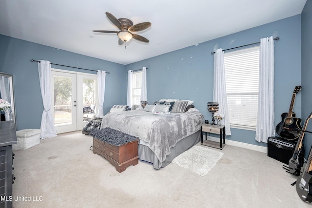 carpeted bedroom with access to exterior, ceiling fan, and french doors