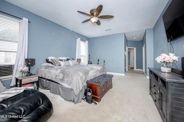 bedroom with ceiling fan and light carpet