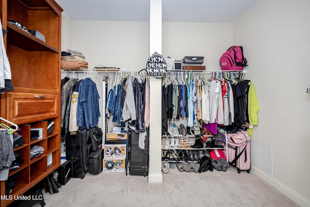 walk in closet with carpet floors