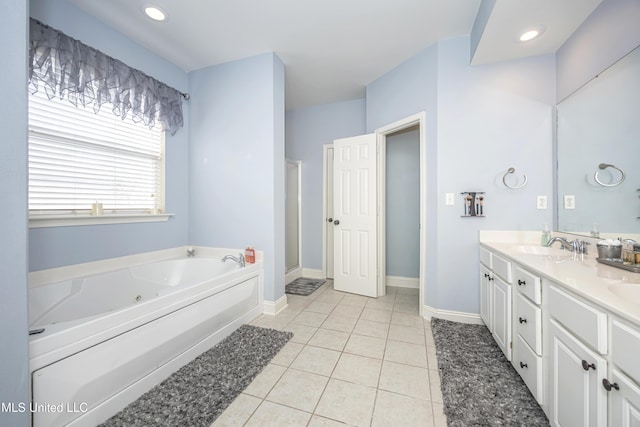 bathroom with vanity, tile patterned floors, and a bathtub