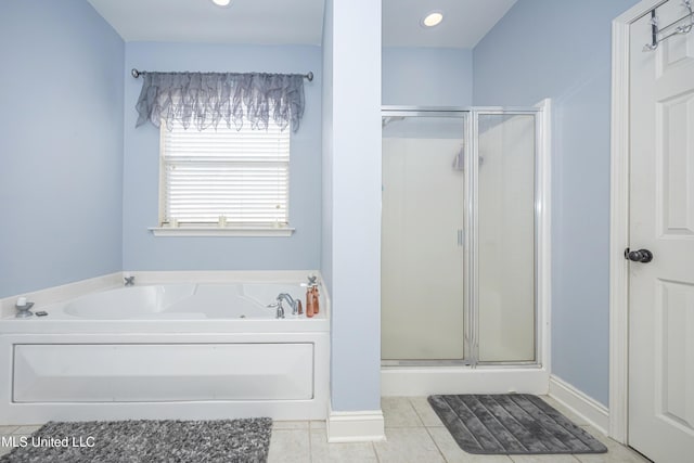 bathroom with independent shower and bath and tile patterned flooring