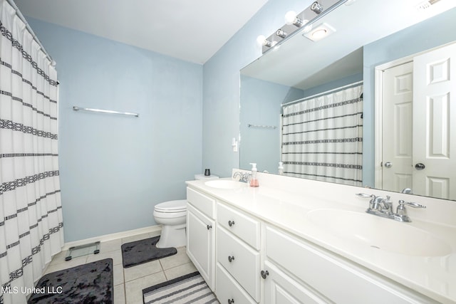 bathroom featuring tile patterned flooring, vanity, and toilet