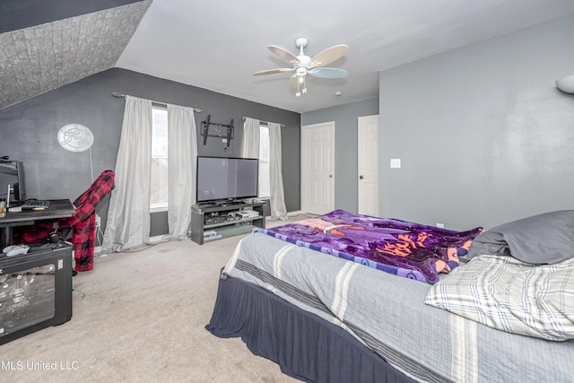 carpeted bedroom featuring vaulted ceiling and ceiling fan