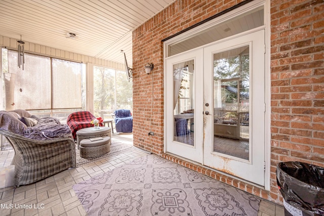 sunroom featuring a healthy amount of sunlight, wooden ceiling, and french doors