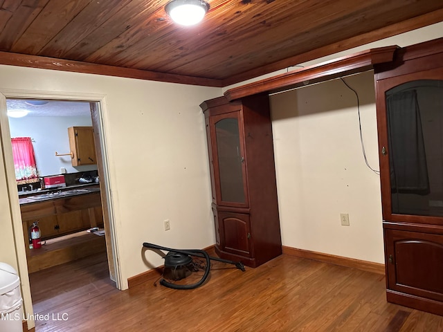 bedroom featuring wood-type flooring and wood ceiling