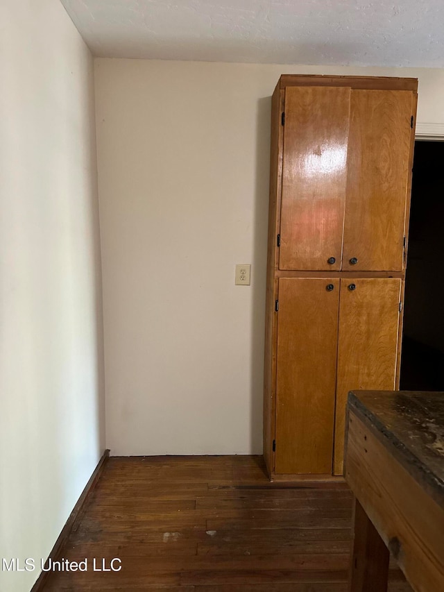 hall with dark hardwood / wood-style floors