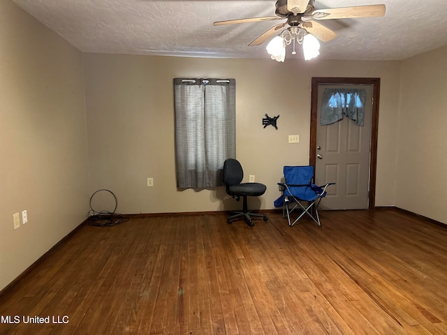 interior space featuring hardwood / wood-style floors, a textured ceiling, and ceiling fan