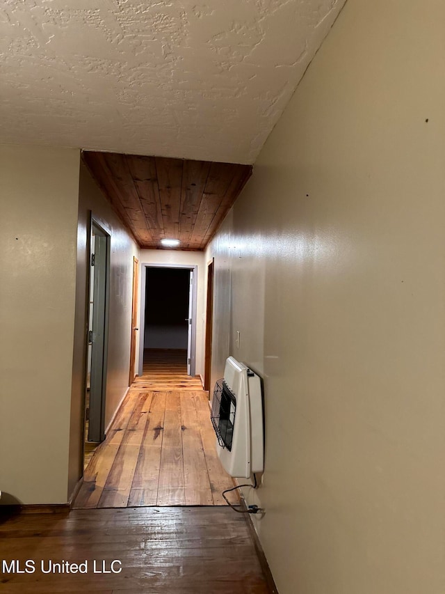 corridor featuring light wood-type flooring and heating unit