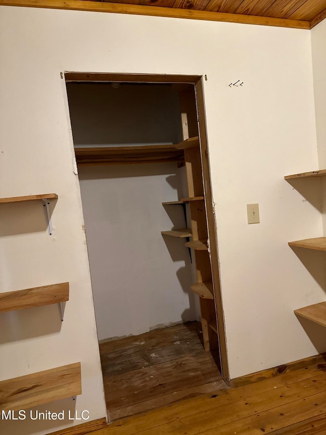 stairs with hardwood / wood-style floors and wooden ceiling