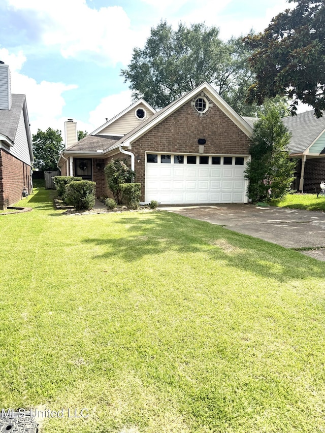 167 Tackett Run, Southaven, MS 38671 - view of front of home featuring brick siding, a garage, a front yard, and driveway