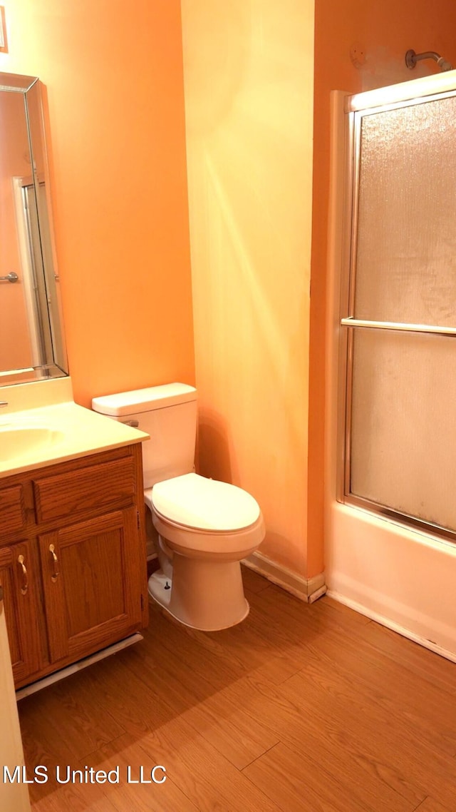 167 Tackett Run, Southaven, MS 38671 - full bathroom featuring vanity, wood finished floors, and shower / bath combination with glass door
