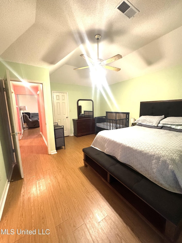 167 Tackett Run, Southaven, MS 38671 - bedroom with wood finished floors, a textured ceiling, vaulted ceiling, and a ceiling fan