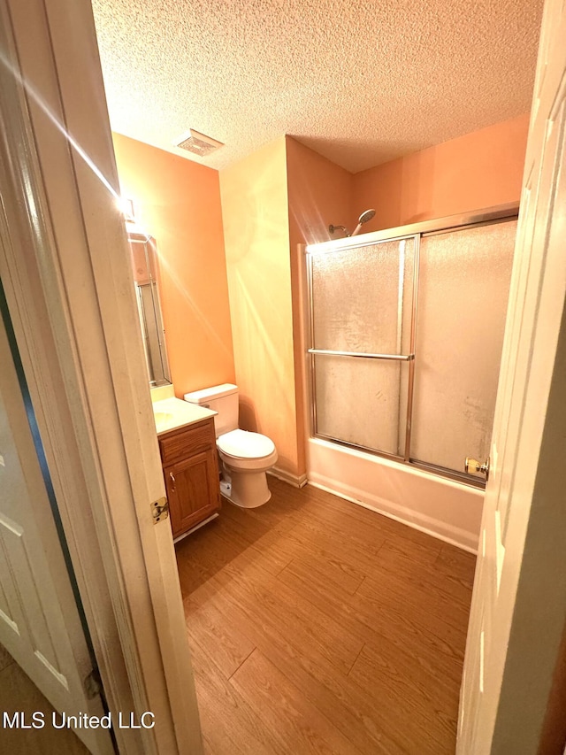 167 Tackett Run, Southaven, MS 38671 - full bath featuring vanity, a textured ceiling, wood finished floors, and combined bath / shower with glass door