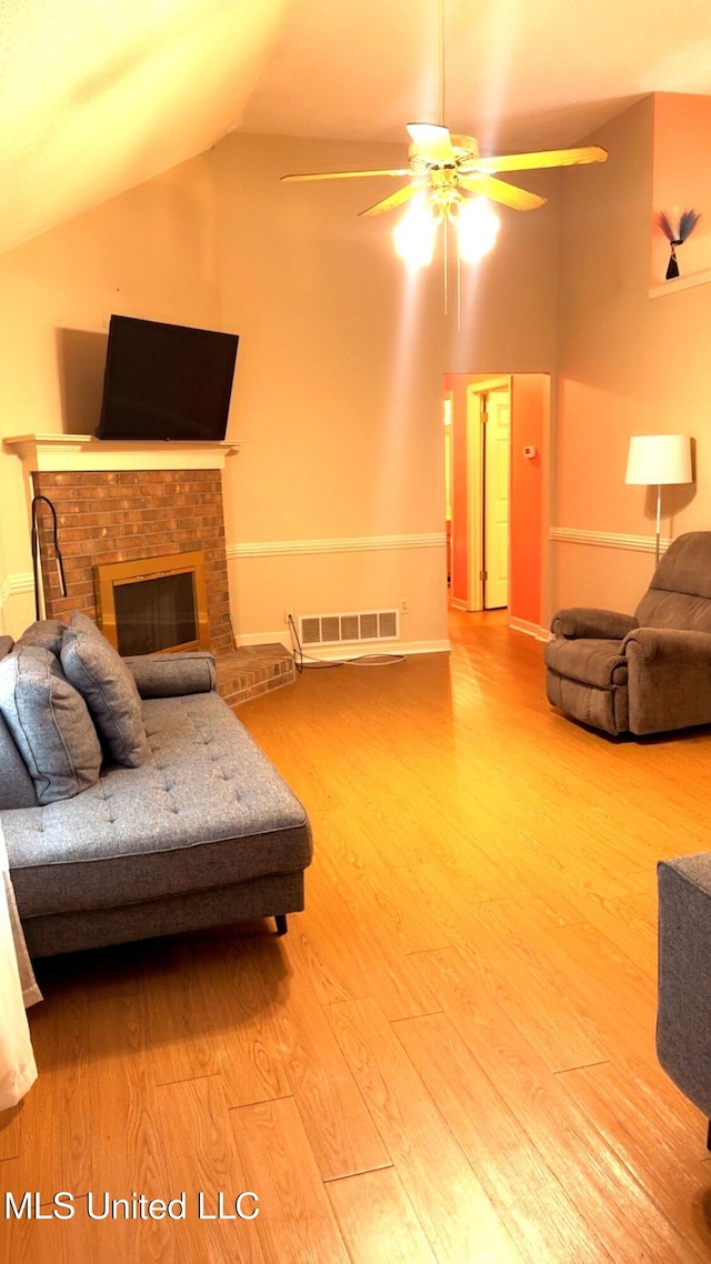 167 Tackett Run, Southaven, MS 38671 - living room featuring a ceiling fan, wood finished floors, lofted ceiling, and a brick fireplace