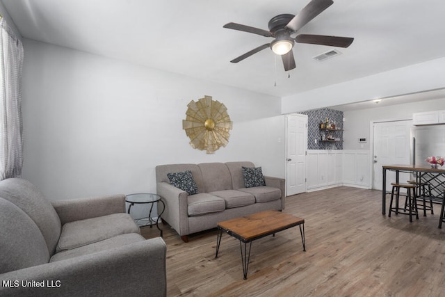 living room with hardwood / wood-style floors and ceiling fan