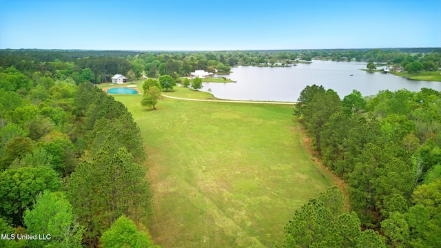 drone / aerial view featuring a water view and a view of trees