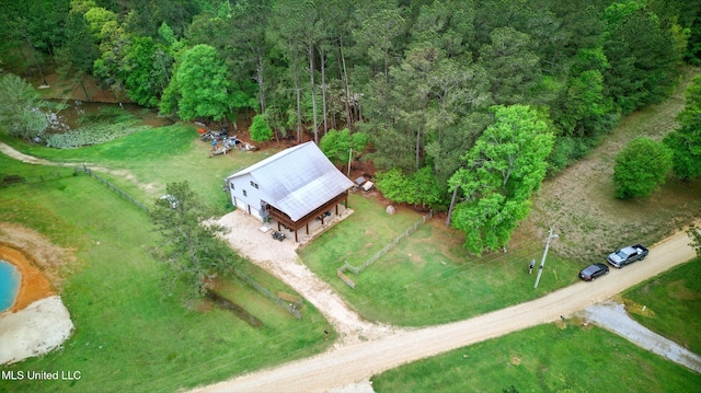 drone / aerial view featuring a forest view