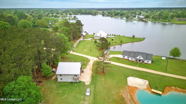 drone / aerial view featuring a water view and a view of trees