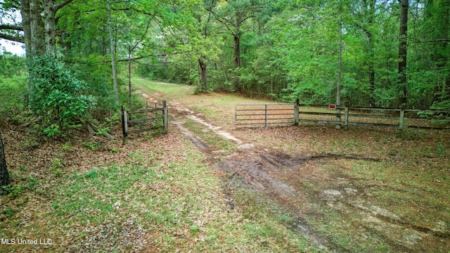 view of yard with a view of trees and fence