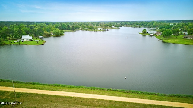 aerial view with a forest view and a water view