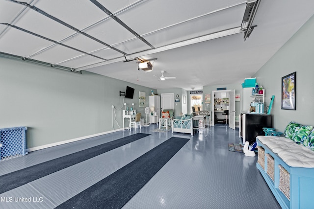 garage with baseboards, a ceiling fan, and a garage door opener