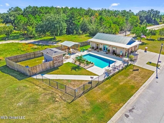 view of swimming pool featuring a fenced in pool, fence, a lawn, and a patio