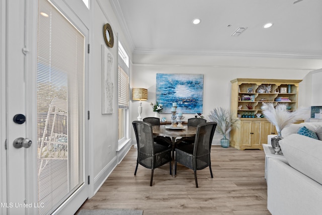 dining room featuring visible vents, baseboards, ornamental molding, light wood-type flooring, and recessed lighting