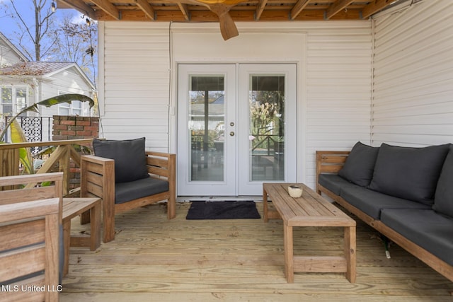 wooden terrace with french doors and an outdoor hangout area