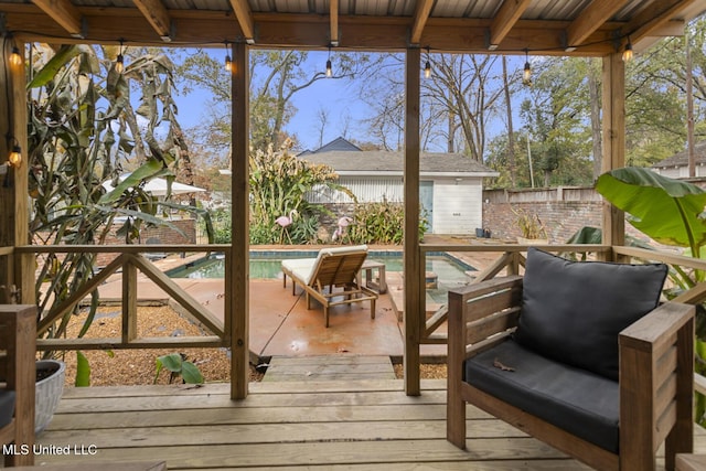 wooden deck featuring a fenced in pool