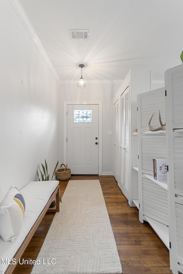 foyer featuring dark hardwood / wood-style flooring and ornamental molding