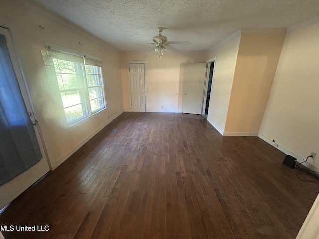 empty room featuring a textured ceiling, ceiling fan, ornamental molding, and dark wood-type flooring