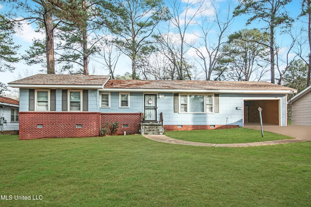 ranch-style home with a front lawn and a garage