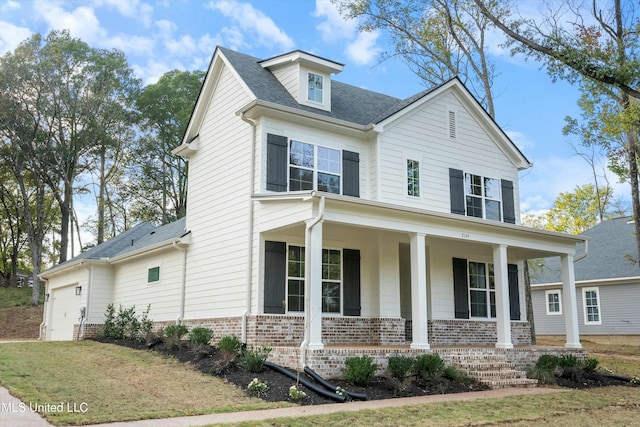 view of front of house with a porch and a garage