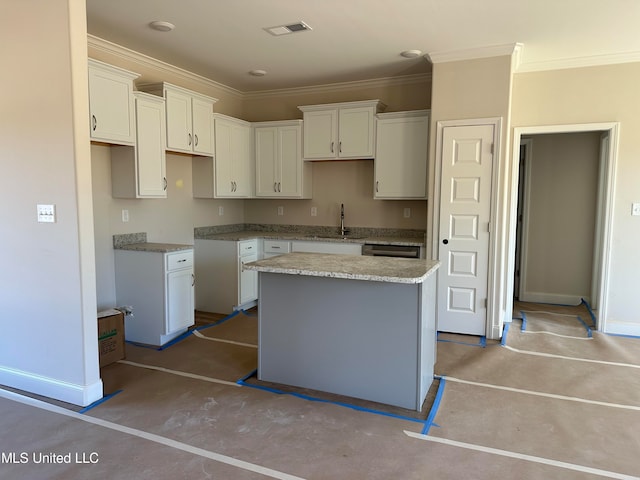 kitchen with a kitchen island, ornamental molding, white cabinetry, and sink