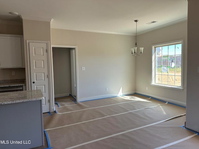 unfurnished dining area with crown molding and an inviting chandelier