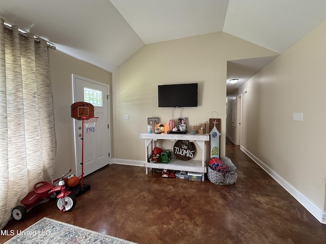 game room with finished concrete floors, baseboards, and lofted ceiling