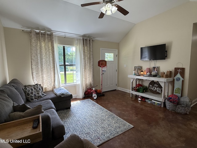living room featuring a ceiling fan, vaulted ceiling, baseboards, and concrete floors