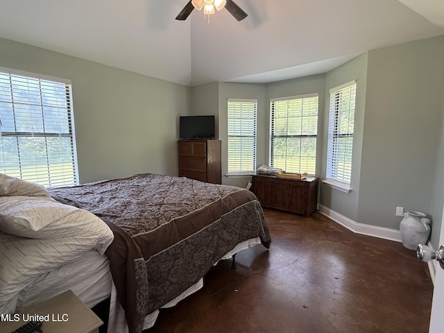bedroom with finished concrete flooring, baseboards, vaulted ceiling, and a ceiling fan