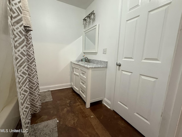full bathroom featuring concrete floors, vanity, and baseboards