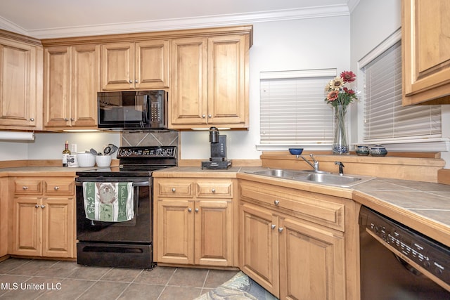 kitchen with tile countertops, ornamental molding, light tile patterned flooring, black appliances, and a sink