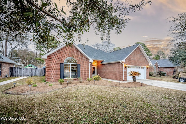 view of front of home with a yard and a garage