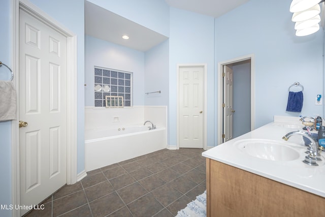 full bath featuring tile patterned flooring, a garden tub, double vanity, and a sink