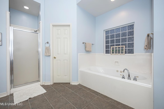 full bath featuring tile patterned flooring, a bath, recessed lighting, and a stall shower