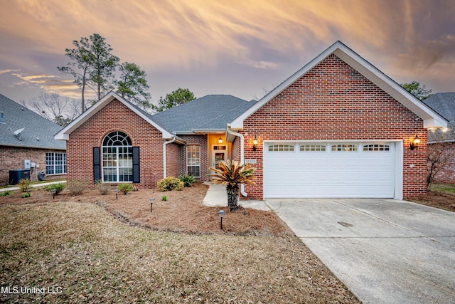 single story home featuring brick siding, driveway, a shingled roof, and a garage