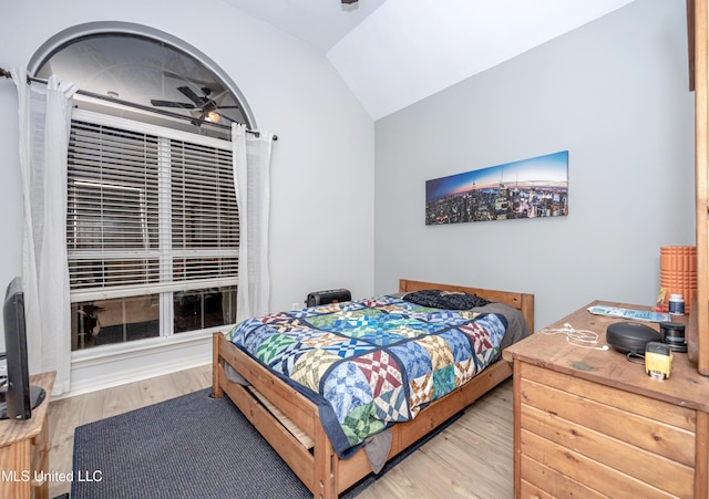 bedroom with lofted ceiling and wood finished floors